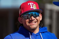 Texas Rangers outfielder Alejandro Osuna waits his turn to take batting practice during a...