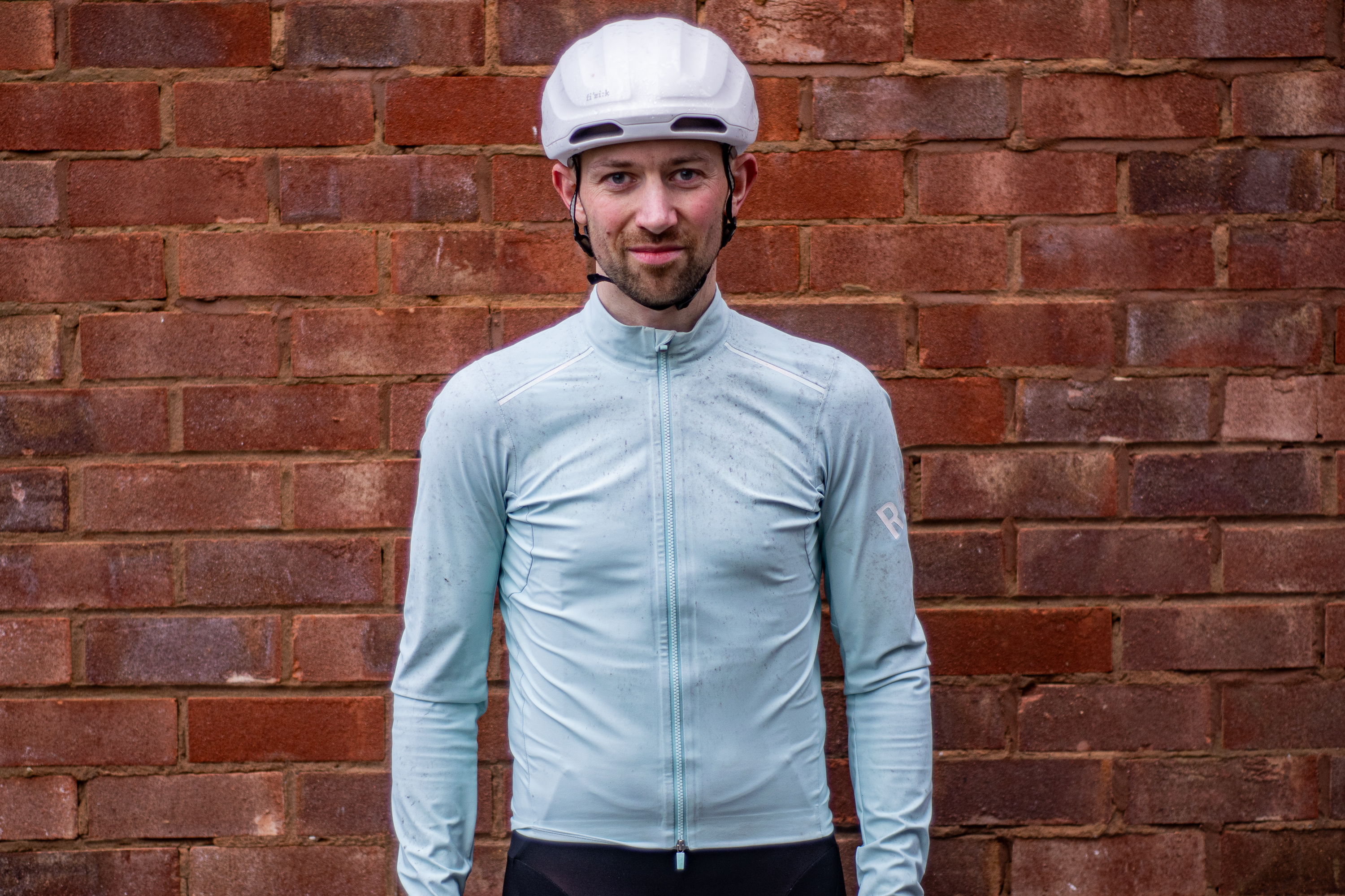 A man wearing a green Rapha Shadow jersey