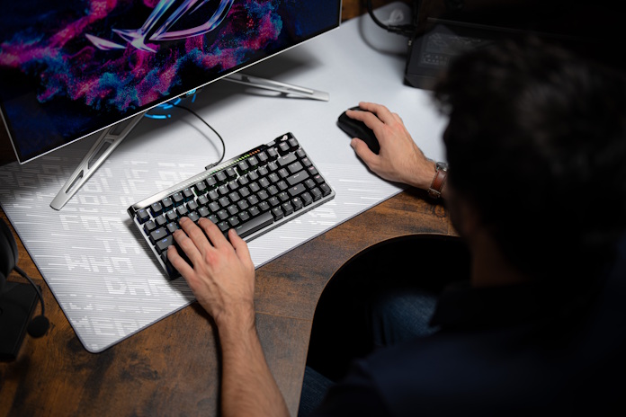 A gamer uses high-performance ROG peripherals in a PC gaming setup