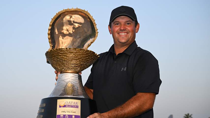Patrick Reed poses with the trophy following victory at the Qatar Masters at Doha Golf Club. (Stuart Franklin/Getty Images)