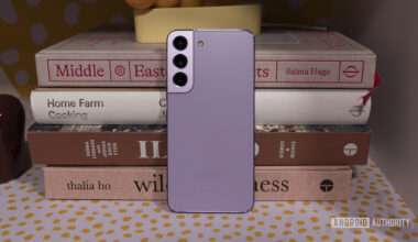 Samsung Galaxy S22 Bora Purple Leaning Against Books