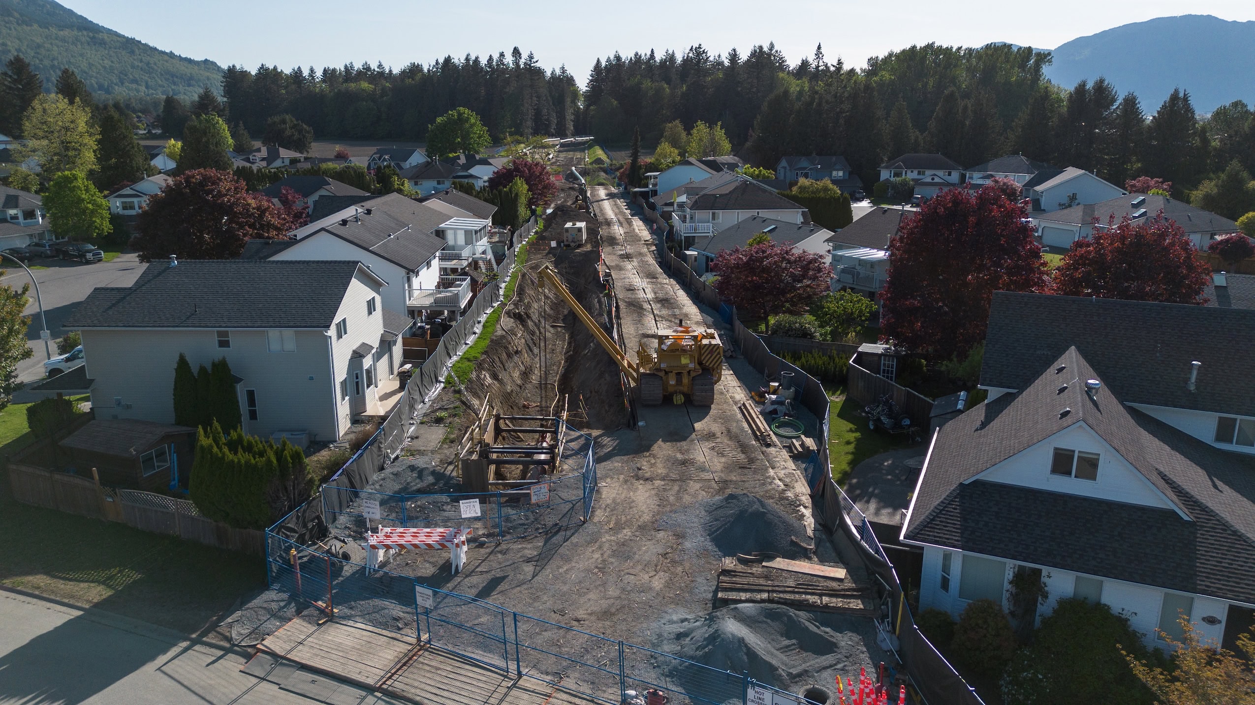 A pipeline under construction is put in place along a corridor cutting through a residential neighbourhood in Chilliwack, B.C.