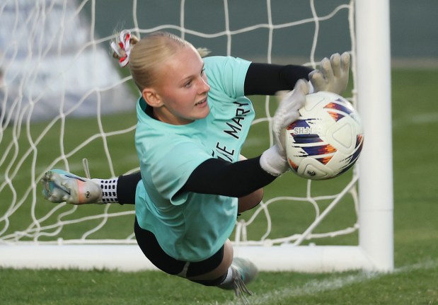 Lake Mary High goalkeeper Lily Ellis makes an athletic save on a penalty kick during the FHSAA Class 7A state championship game against Cypress Bay High at Spec Martin Stadium in DeLand on Wednesday, February 25, 2026. Lake Mary won the match 4-3 on penalty kicks to claim the state championship. (Stephen M. Dowell/Orlando Sentinel)