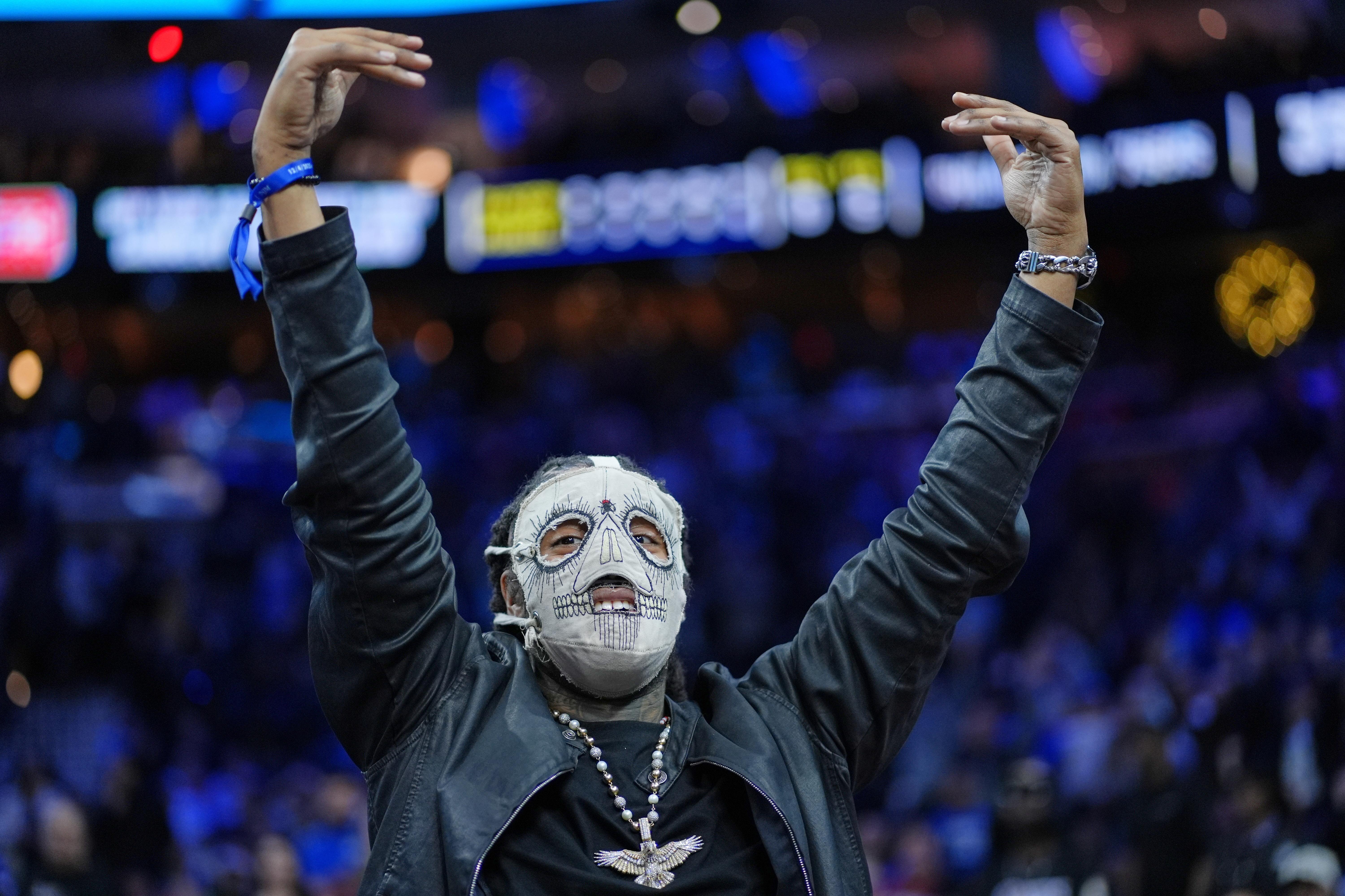 FILE – Rapper Skrilla reacts during an NBA basketball game...