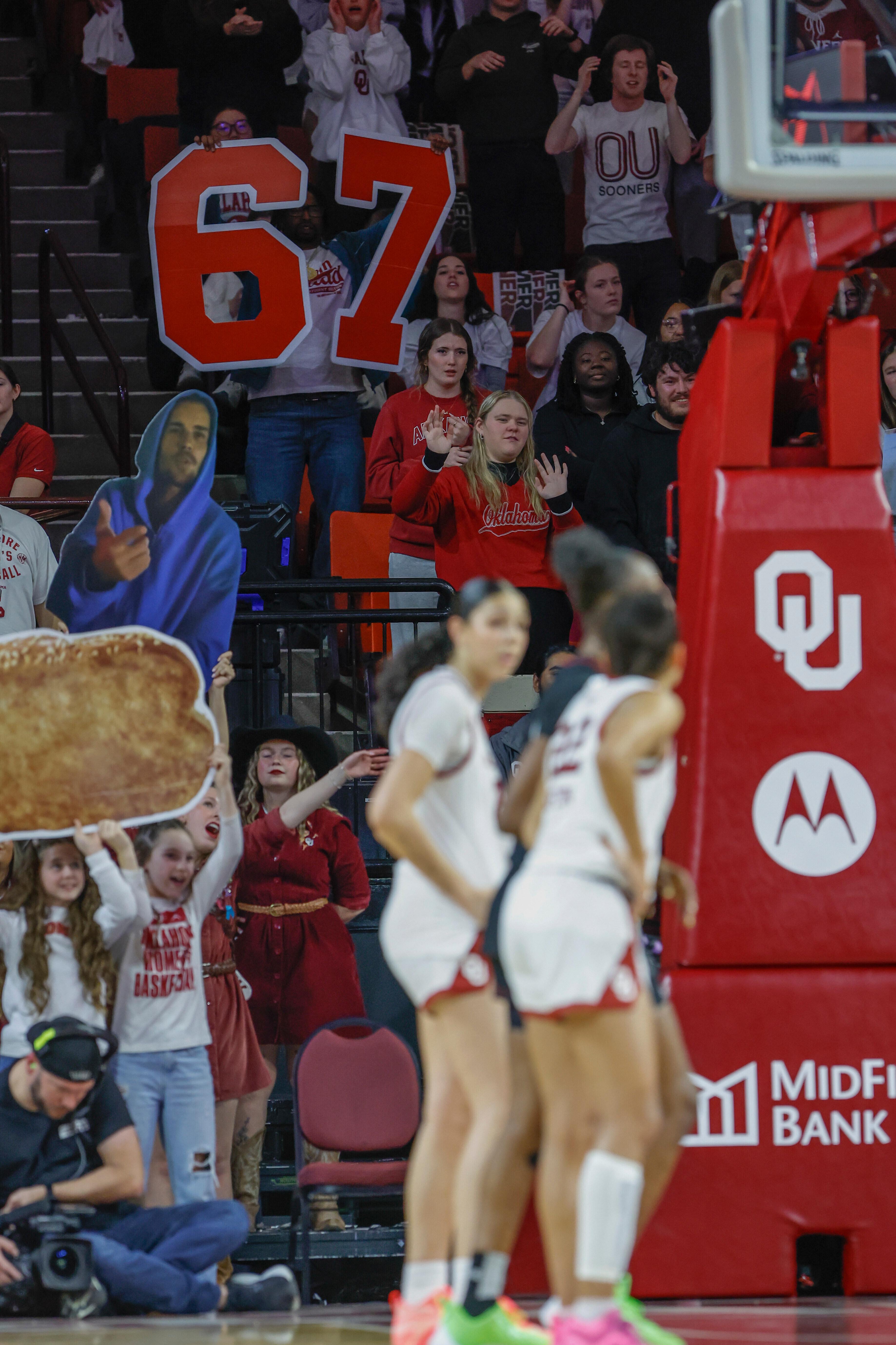 FILE – Oklahoma fans hold up a giant 6-7 sign...