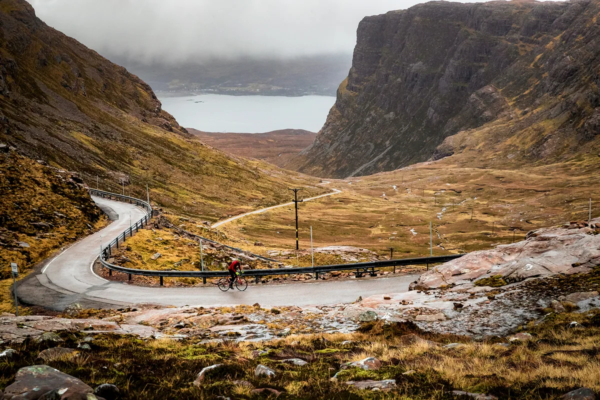 lone cyclist riding in Bealach-na-Ba - Scottish Highlands