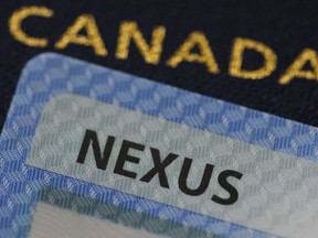 A NEXUS card and a Canadian passport are pictured in Ottawa on Tuesday, Jan. 17, 2023.