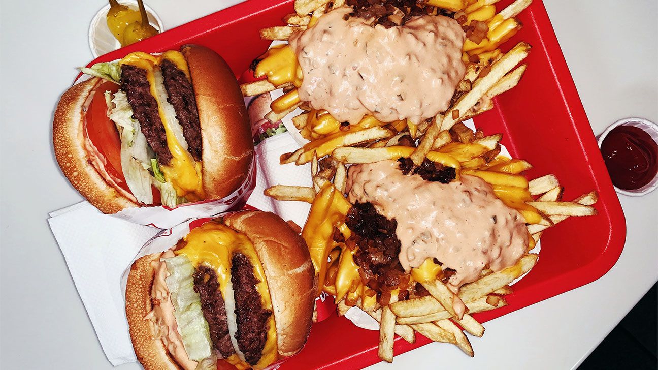 Image of hamburgers and french fries covered in sauce