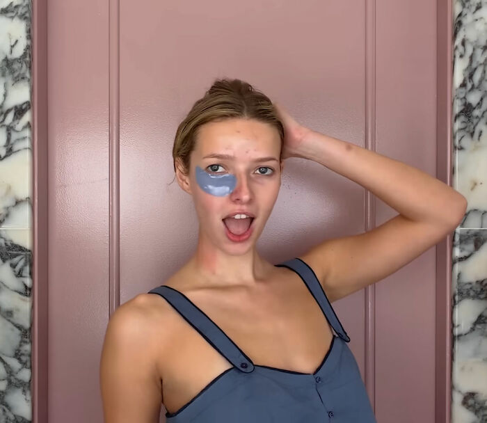 Apple Martin with under-eye mask, posing against pink wall, revealing cosmetic procedures she has had in casual attire. Apple Martin with under-eye mask, posing against pink wall, revealing cosmetic procedures she has had in casual attire.