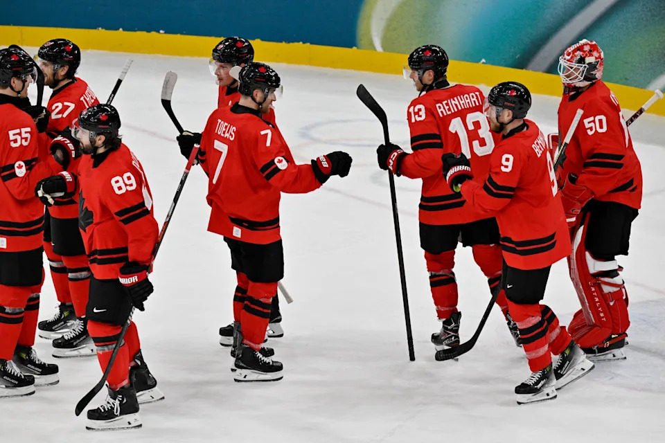 Canada's players celebrate after winning the men's preliminary round Group A Ice Hockey match between Canada and France at the Milano Santagiulia Ice Hockey Arena during the Milano Cortina 2026 Winter Olympic Games in Milan, on February 15, 2026. Canada won the match 10-2. (Photo by Alexander NEMENOV / AFP via Getty Images)