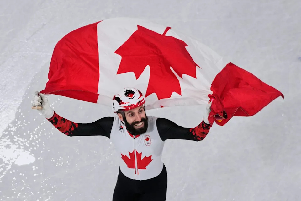 Steven Dubois of Canada celebrates the gold gold after the short track speed skating men's 500m final at the 2026 Winter Olympics, in Milan, Italy, Wednesday, Feb. 18, 2026.(AP Photo/Bernat Armangue)
