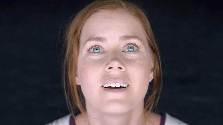 Amy Adams as Louise Banks looking at aliens Abbott and Costello in Arrival