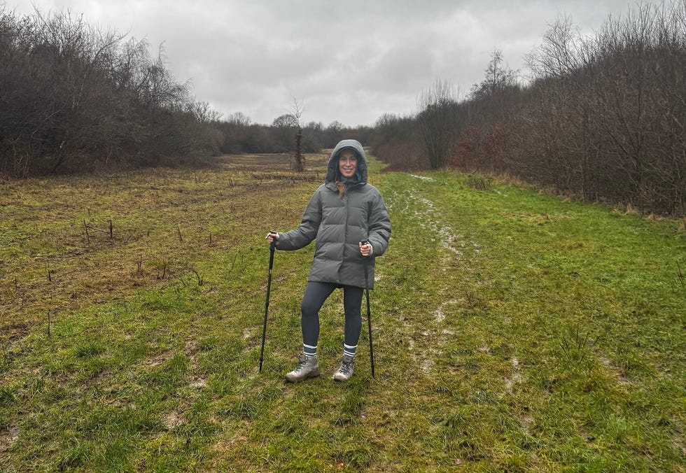hiker on a muddy pathway in a cloudy outdoor setting hiker on a muddy pathway in a cloudy outdoor setting