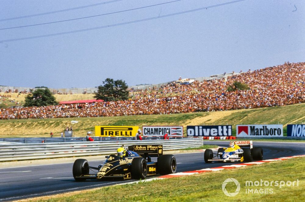 Ayrton Senna, Lotus 98T Renault, leads Nelson Piquet, Williams FW11 Honda