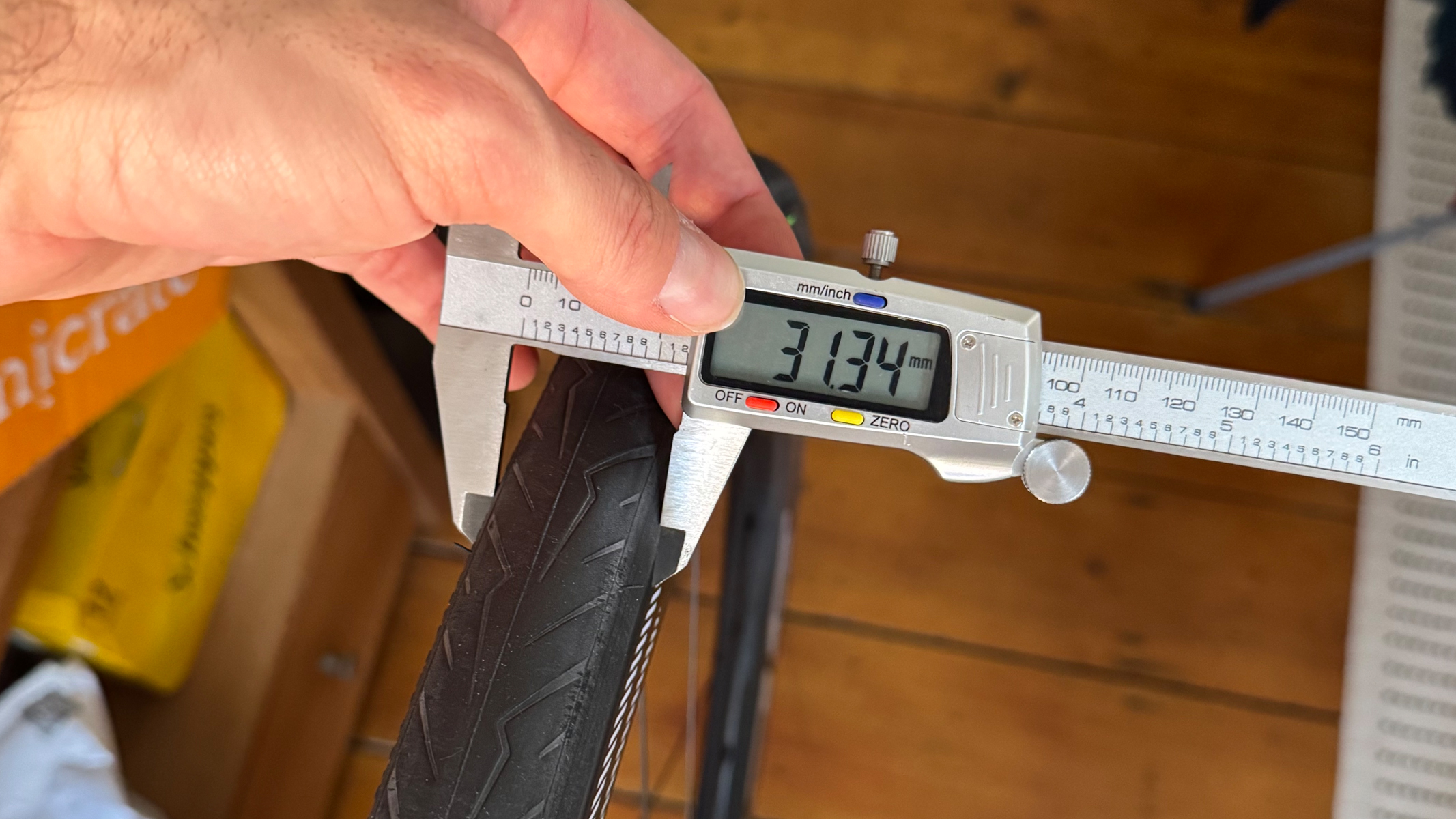 A Pirelli Cinturato Velo tyre being measured with vernier callipers