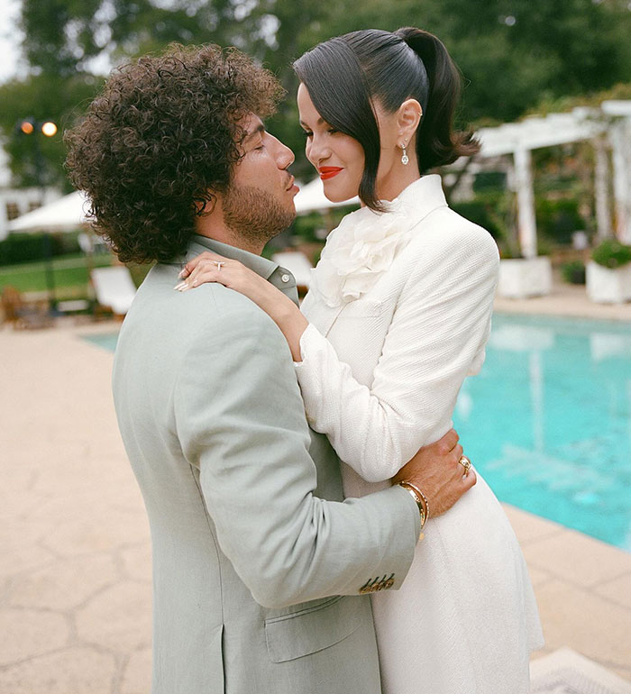 Couple embracing near poolside, highlighting Taylor Swift's gift to Selena Gomez and the resulting backlash in public discussions. Couple embracing near poolside, highlighting Taylor Swift's gift to Selena Gomez and the resulting backlash in public discussions.