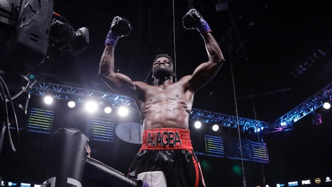 Nigeria's Efe Ajagba celebrates after beating Romania's Razvan Cojanu in a heavyweight boxing match Saturday, March 7, 2020.