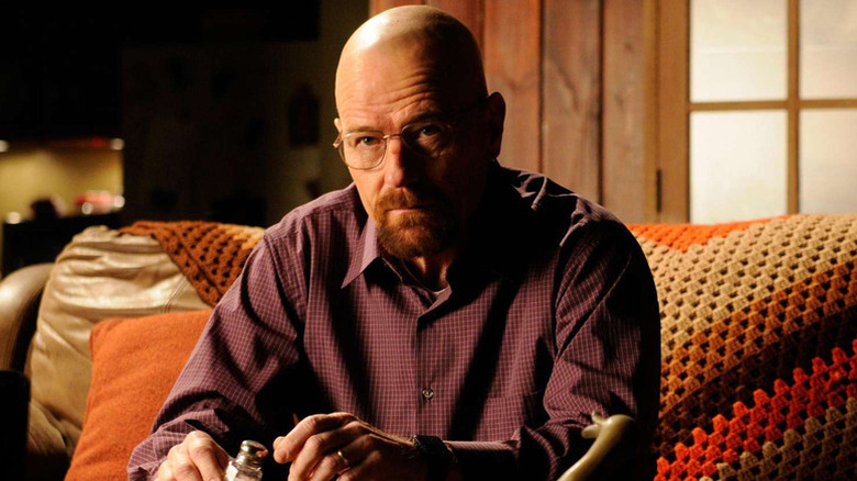 Walter White (Bryan Cranston) looks up while seated on a couch in Breaking Bad