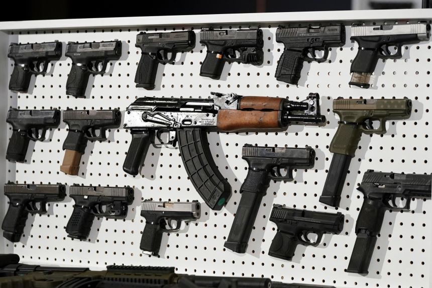 Weapons arrayed after a joint US-Canadian operation to seize firearms illegally smuggled into Canada in 2024. Canadian police say firearm smuggling from the US is a major concern.