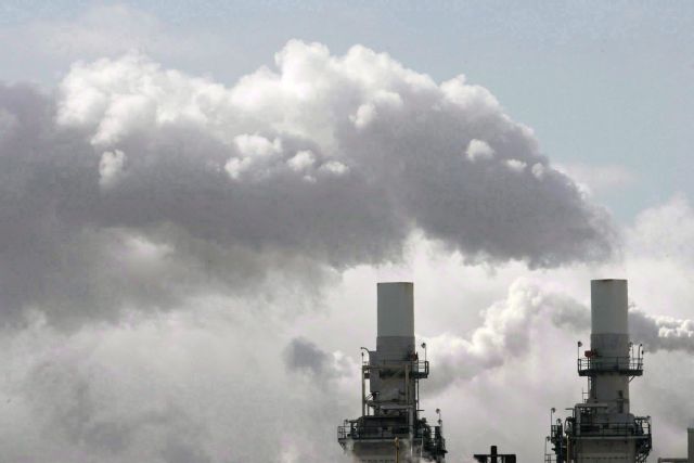 Steam spills out of smoke stacks at a building in Toronto, Friday, Feb. 18, 2005. THE CANADIAN PRESS/Adrian Wyld