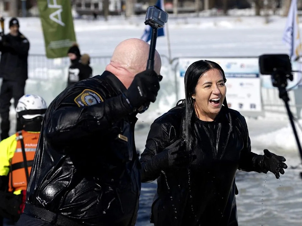 Quebec Security Minister Ian Lafrenière and Montreal Mayor Soraya Martinez Ferrada laugh after jumping in the icy water of the St. Lawrence River during the 18th annual SPVM polar plunge in Montreal.