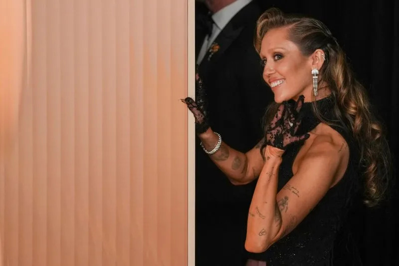 Academy Award presenter Miley Cyrus prepares to join Gareth John, Richard King, Ron Bartlett, and Doug Hemphill of "Dune: Part Two" celebrating backstage after winning an Oscar during the Academy Awards in March. File Photo by Pat Benic/UPI