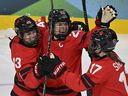 Marie-Philip Poulin, centre, will miss Team Canada's preliminary round game against Team USA with lower-body injury, according to Hockey Canada.