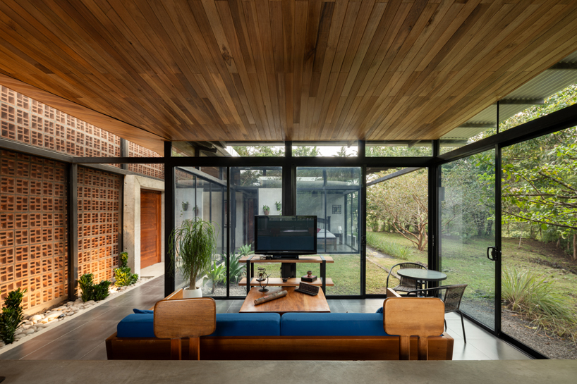 a series of porous brick partitions enclose central garden within costa rica residence