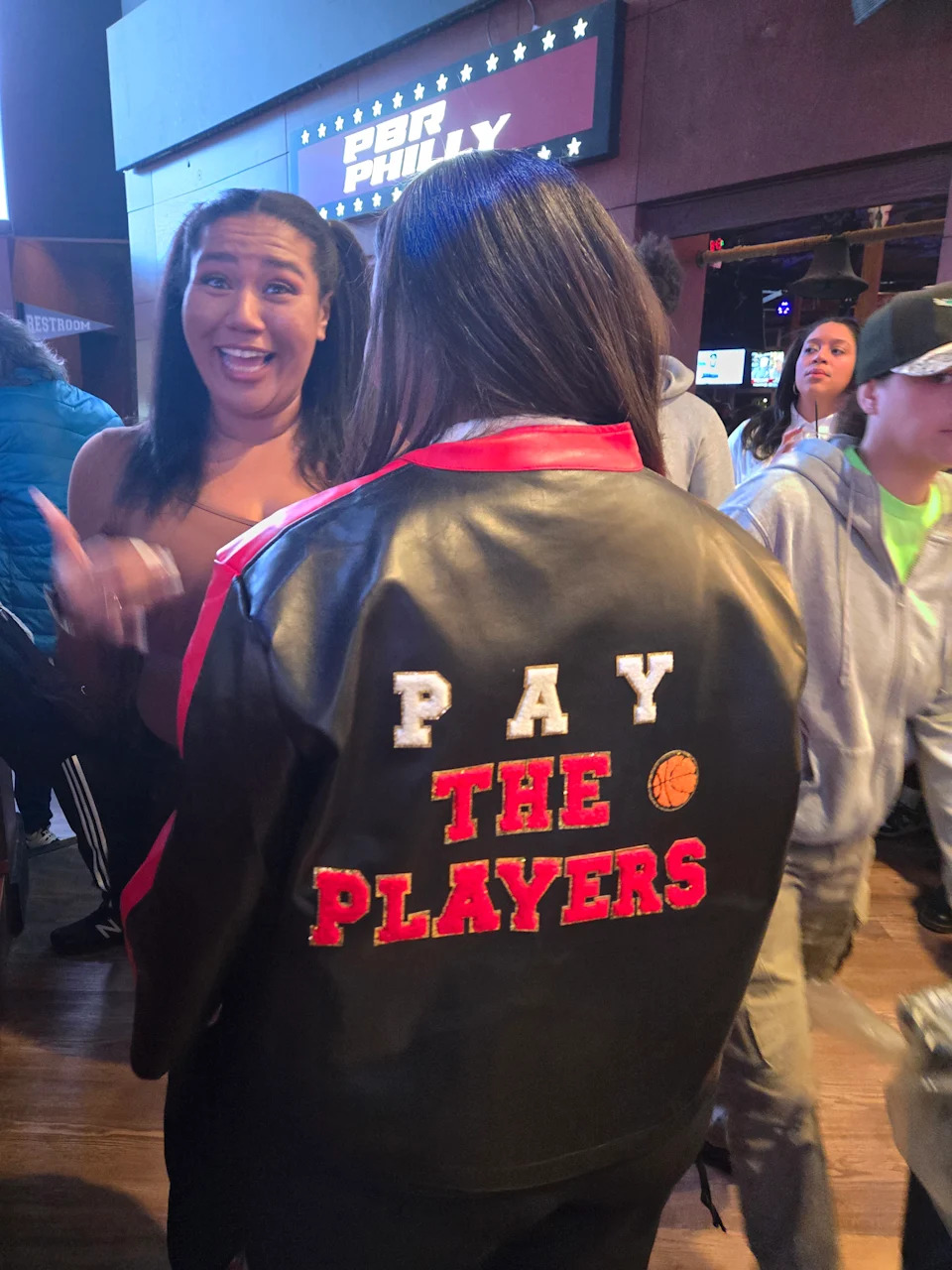 Cierra Cobb shows off her customized leather jacket alongside her sister, Chelsea. The two made the trip to Philadelphia from Hawaii.