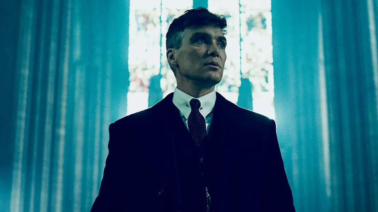 Tommy Shelby looks out in front of a church window on Peaky Blinders.