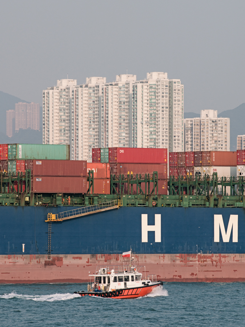 photographer captures cargo ships passing by on his ferry ride home