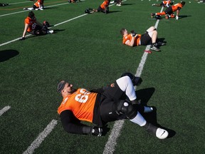 B.C. Lions offensive lineman Jarell Broxton stretches along with the rest of his teammates during the CFL football team's training camp in Kamloops on May 15, 2023.