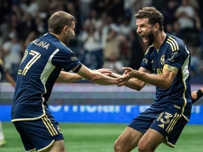Vancouver Whitecaps' Thomas Muller (13) celebrates his goal against the Philadelphia Union, with Vancouver Whitecaps' Giuseppe Bovalina (27) during the second half of an MLS soccer match in Vancouver, on Saturday, Sept. 13, 2025.