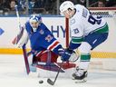 Vancouver Canucks centre Marco Rossi (93) attempts to shoot the puck past New York Rangers goaltender Jonathan Quick (32) on Dec. 16, 2025, in New York. Rossi returns to the Canucks' lineup against the Winnipeg Jets on Wednesday night at Rogers Arena. 