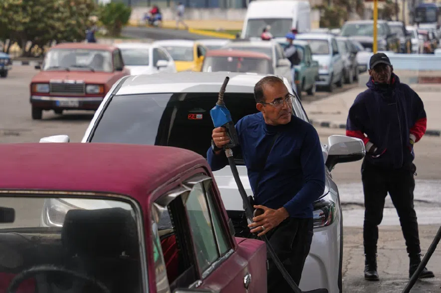 A driver refuels as others wait in a long line behind to fill up at a gas station in Havana, Cuba, Tuesday, Jan. 27, 2026.