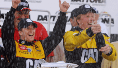 Oct 19, 2025; Talladega, Alabama, USA; Cars race by Talladega signage during stage one of the YellaWood 500 at Talladega Superspeedway