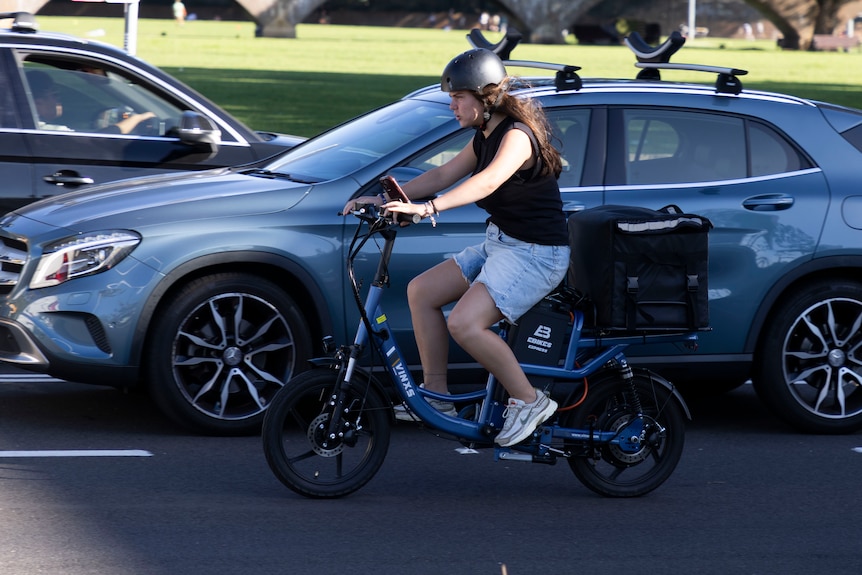 a cyclist riding on the road amongst car traffic