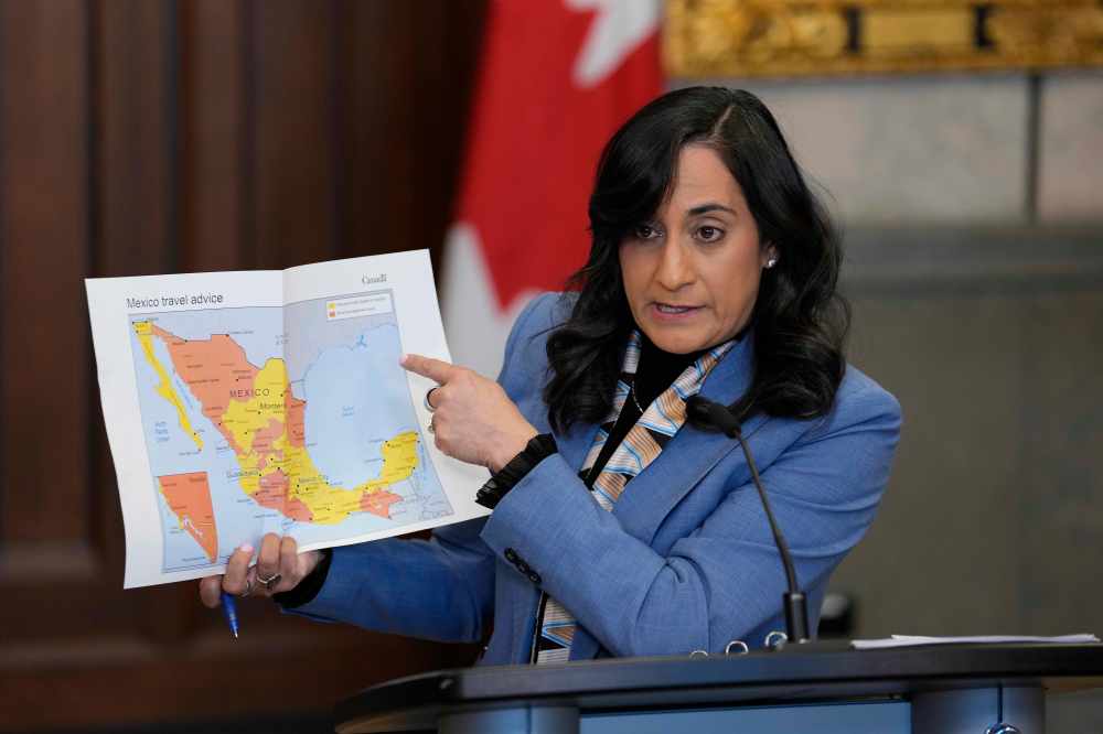 Minister of Foreign Affairs Anita Anand points to a map as she provides an update regarding the security situation in Mexico, in the Foyer of the House of Commons on Parliament Hill in Ottawa, on Monday, Feb. 23, 2026. THE CANADIAN PRESS/Justin Tang