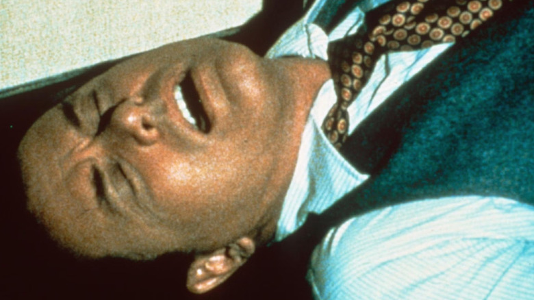 Larry Hagman as JR Ewing lies on the ground in Dallas