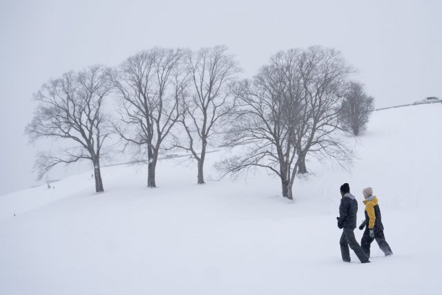 Pedestrians walk through snow during a winter storm that closed schools and delayed travel in Halifax on Monday, Jan. 26, 2026. THE CANADIAN PRESS/Darren Calabrese
