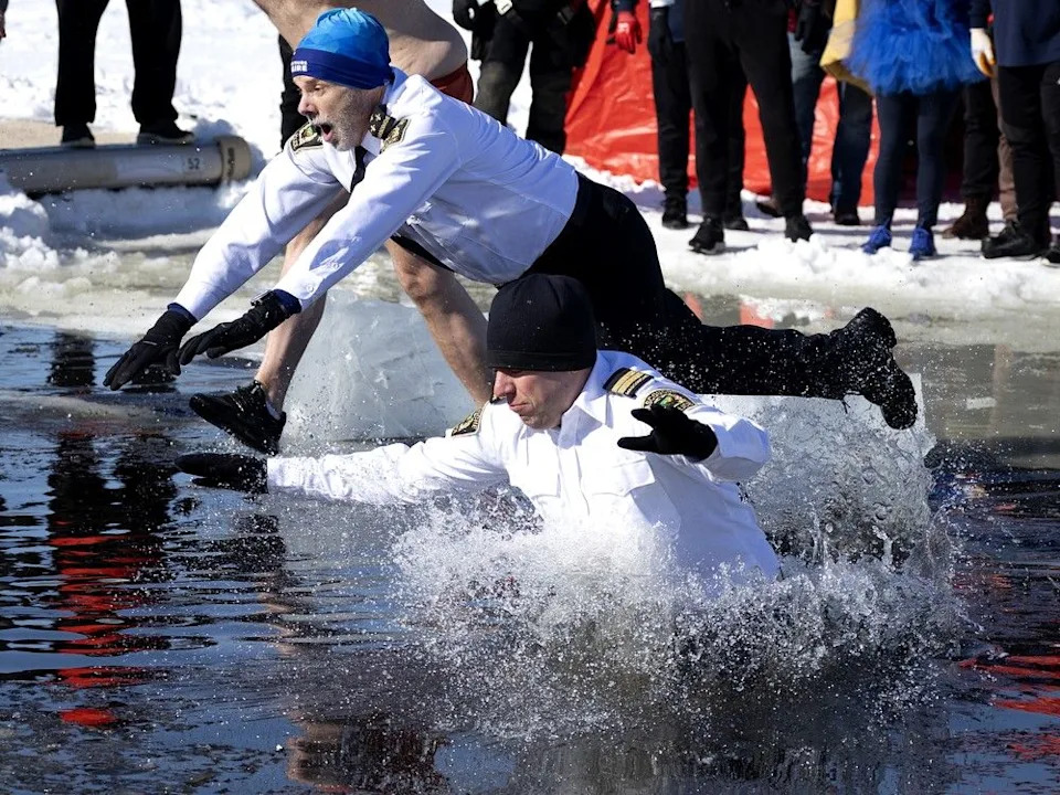 Members of the Mascouche police force jump into the St. Lawrence River during the 18th annual SPVM polar plunge in Montreal on Saturday, Feb. 21, 2026.