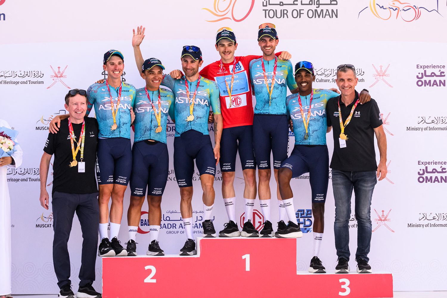 XDS-Astana Team's Italian rider Christian Scaroni (4R) celebrates with teammates on the podium after winning the 5th and last stage, and being winner overall of the Tour of Oman cycling race from Nizwa to Green Mountain, on February 11, 2026. (Photo by Loic VENANCE / AFP via Getty Images)