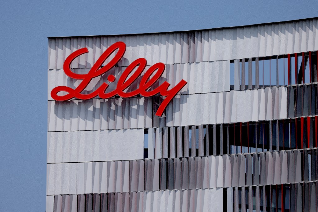 The red Eli Lilly logo is shown on a modern building in San Diego.