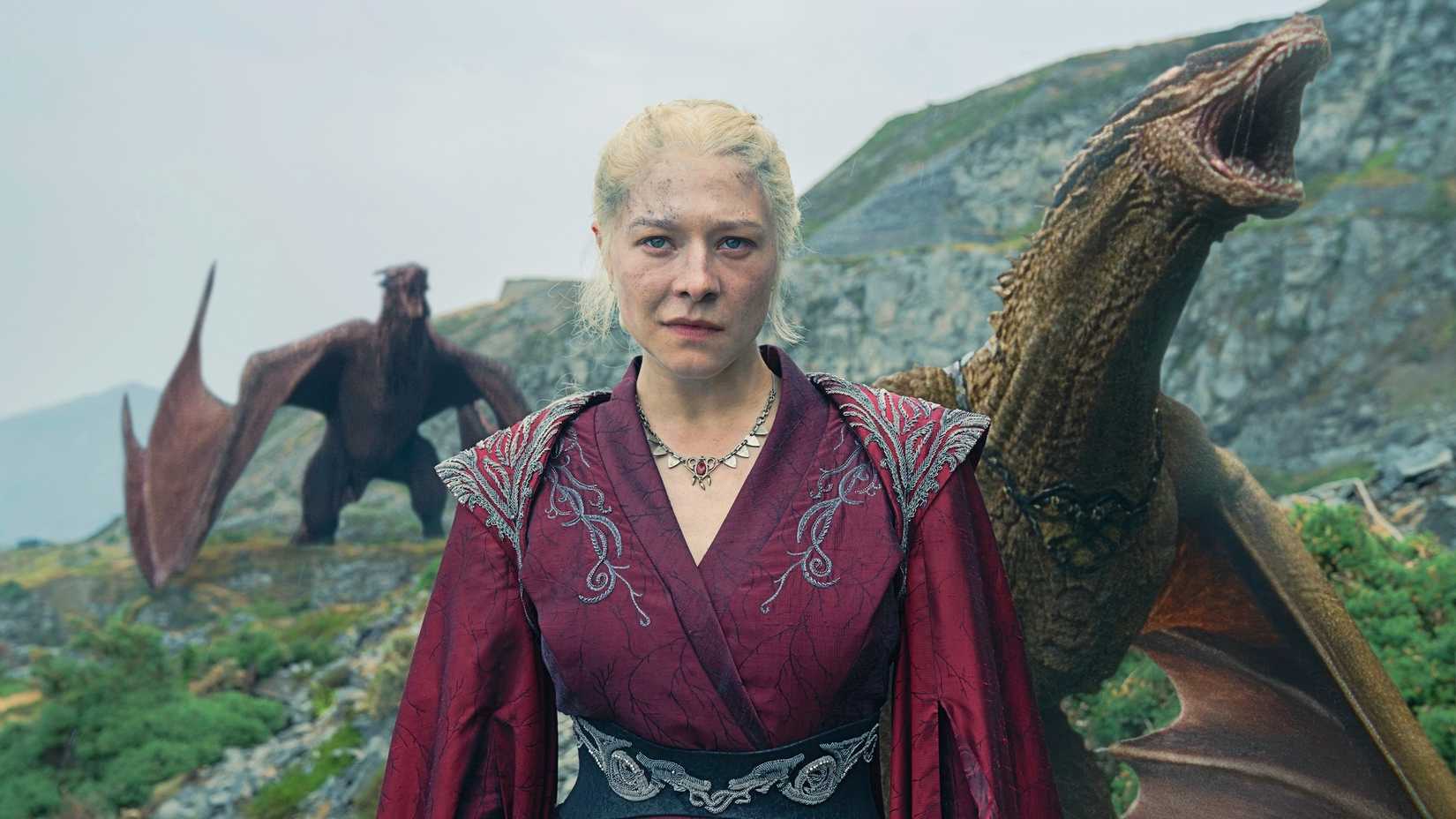 Emma D'Arcy as Queen Rhaenyra Targaryen with dragons behind her in House of the Dragon season 2