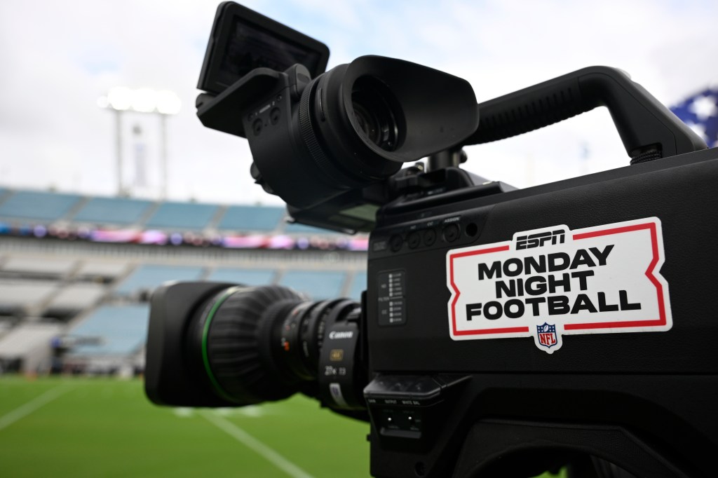 An ESPN Monday Night Football logo is displayed on a broadcast camera at an NFL game.
