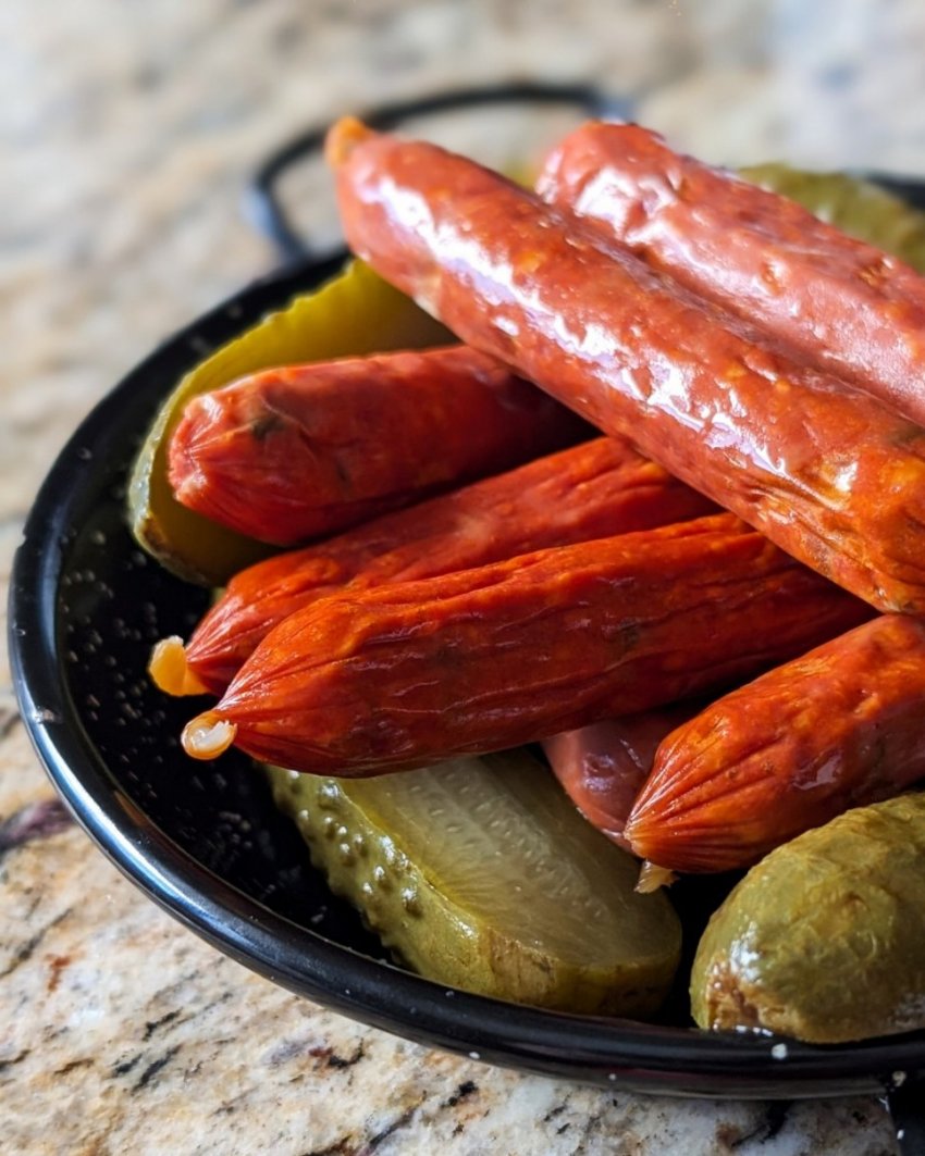 A bowl of dill pickle pepperoni and sliced pickles from European Market in Calgary.