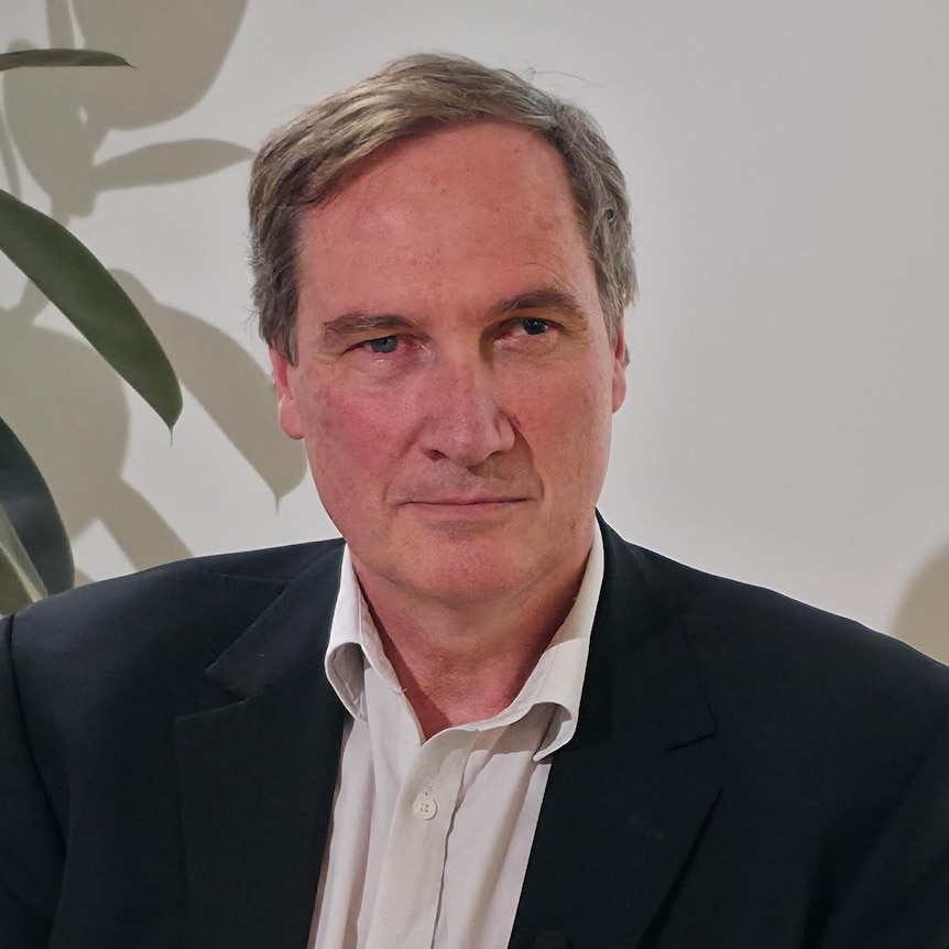 Fire safety engineer Ian Moore sitting on a desk