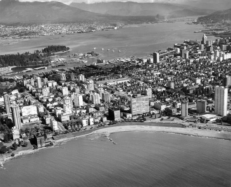 A black and white aerial photo of a city near a waterfront
