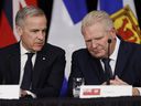 Prime Minister Mark Carney speaks to Ontario Premier Doug Ford during a press conference following a first ministers meeting in Ottawa on Jan. 29, 2026. 
