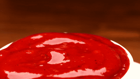 Person dipping fry in ketchup